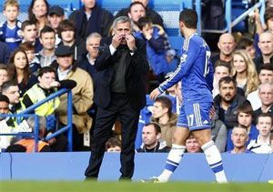 Chelsea's manager Jose Mourinho gestures as he speaks to Eden Hazard during their English Premier League soccer match against Cardiff City at Stamford Bridge in London, on Saturday