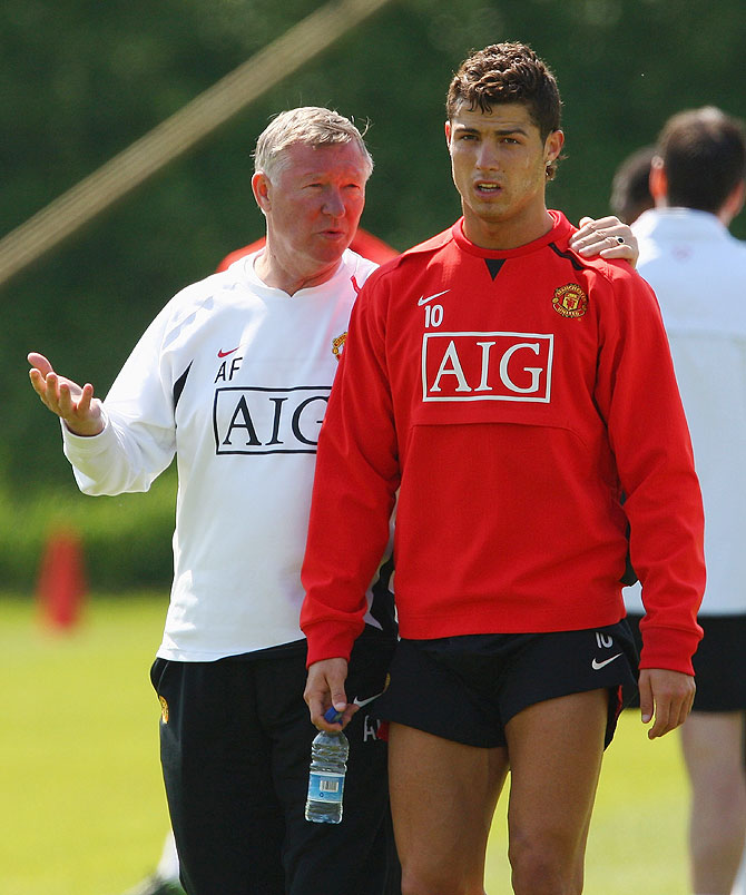 Alex Ferguson the manager of Manchester United talks with Cristiano Ronaldo