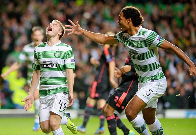 James Forrest (left) of Celtic is congratulated by teammate Virgil van Dijk after scoring the opening goal from the penalty spot during their UEFA Champions League Group H match against Ajax at Celtic Park Stadiumin Glasgow, Scotland, on Tuesday