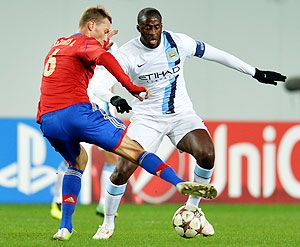 Aleksei Berezutski (L) of PFC CSKA Moscow in action against Yaya Toure of Manchester City FC during the UEFA Champions League Group D match on Wednesday