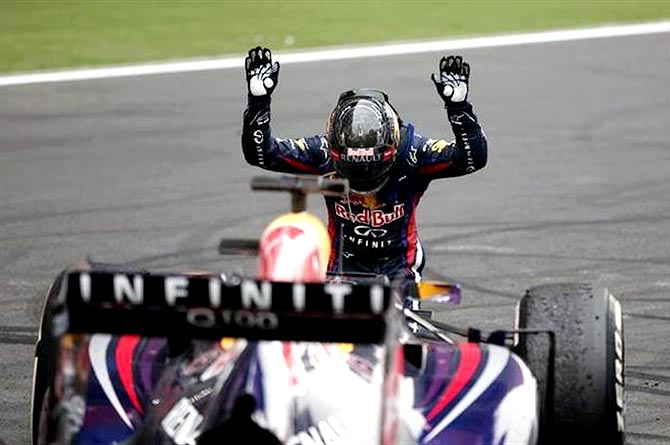 Sebastian Vettel bows down in front of his car after winning the Indian F1 Grand Prix