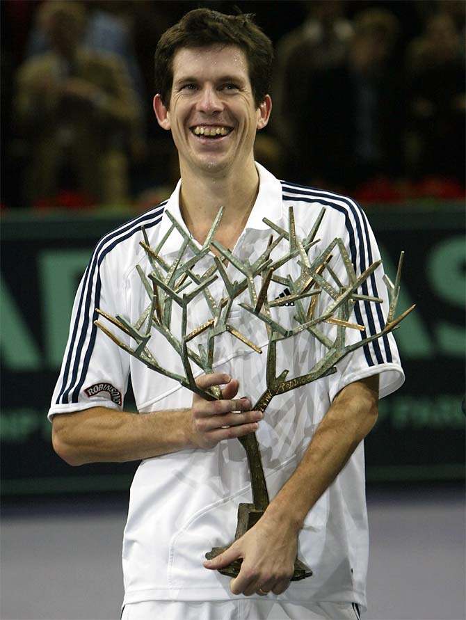 Tim Henman of Great Britain holds the trophy after his straight sets victory in the final against Andrei Pavel of Romainia