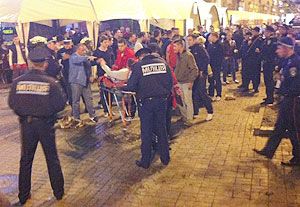 A photo, taken with a mobile phone, shows an injured English soccer fan lying on a stretcher and surrounded by medical personnel