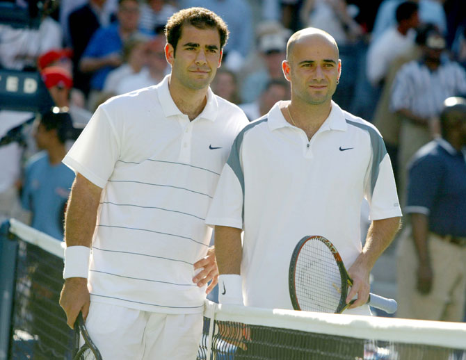 Pete Sampras and Andre Agassi pose at the net before their US Open match