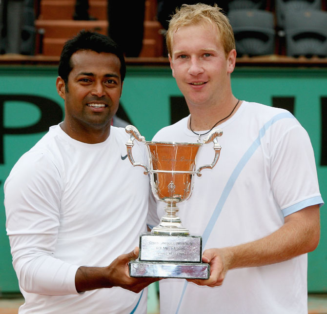 Leander Paes (left) and Lukas Dlouhy of the Czech Republic pose with the French Open trophy