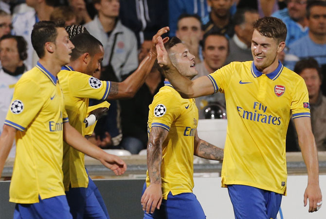 Arsenal Players celebrate after Theo Walcott scored against Olympique Marseille during their Group F  match