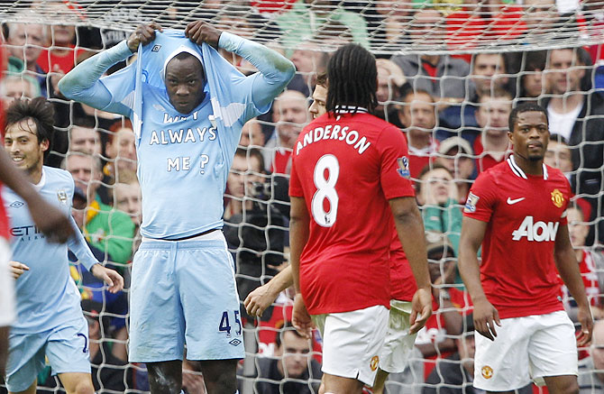 Mario Balotelli celebrates after scoring the opening goal for Manchester City against Manchester United in their English Premier League match at Old Trafford in  October 2011