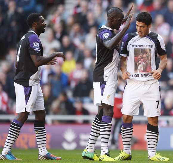 Luis Suarez of Liverpool celebrates his first goal with Mamadou Sakho and Kolo Toure (left)