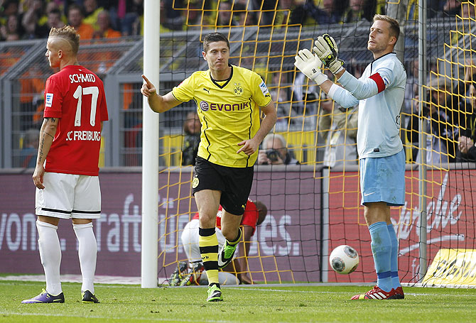 Borussia Dortmund's Robert Lewandowski (centre) celebrates a goal against Freiburg during the Bundesliga match in Dortmund on Saturday