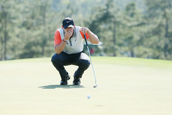 Rory McIlroy of Northern Ireland lines up a putt on the 18th green during the first round of the 2014 Masters Tournament at Augusta National Golf Club on Thursday