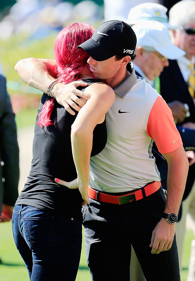 Tennis player Caroline Wozniacki hugs her boyfriend Rory McIlroy of Northern Ireland near the clubhouse on Thursday