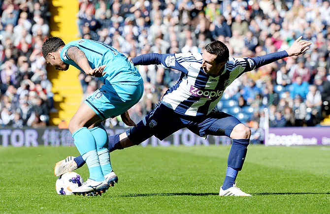 Graham Dorrans of West Bromwich Albion is challenged by Kyle Naughton of Tottenham at The Hawthorns in West Bromwich on Saturday