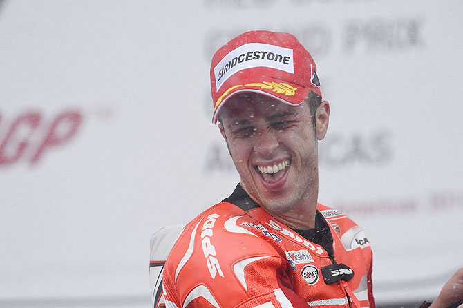 Third place winner Andrea Dovizioso of Italy and Ducati Team celebrates on the podium on Sunday