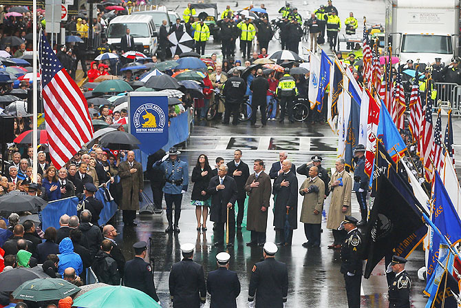 Dignitaries, including U.S. Vice President Joe Biden, survivors and first responders participate in a flag raising ceremony at the finish line in Boston, Massachusetts on Tuesday, marking the one year anniversary of the 2013 Boston Marathon bombings. Biden, other leaders and survivors of the Boston Marathon bombing shared messages of thanks and defiance at a tribute to the three people killed and 264 wounded in the attack exactly one year ago.