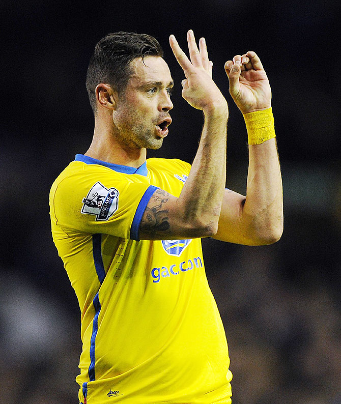 Damien Delaney of Crystal Palace makes a 40 points sign to the supporters following the Barclays Premier League match between Everton and Crystal Palace at Goodison Park on Wednesday