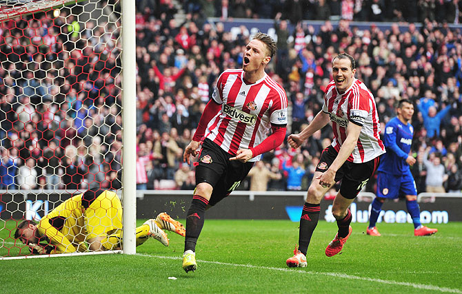 Connor Wickham of Sunderland celebrates scoring his second goal with teammate John O'Shea during the English Premier League match against Cardiff City at the Stadium of Light on Sunday