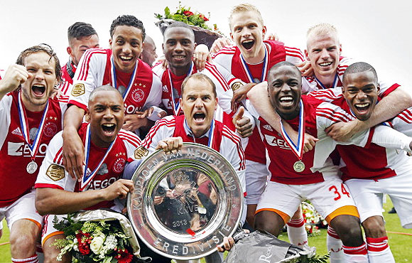 Ajax's Frank de Boer and his players celebrate at Polman stadium in Almelo, The Netherlands on Sunday