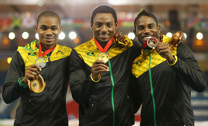 Silver medallist Warren Weir of Jamaica, gold medallist Rasheed Dwyer of Jamaica and bronze medallist Jason Livermore of Jamaica pose on the podium during the medal ceremony for the Mens 200 metres at Hampden Park on Thursday