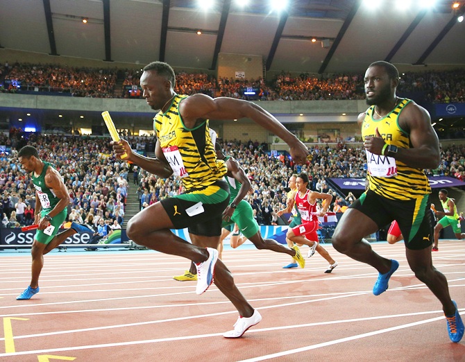 Usain Bolt of Jamaica competes in the Men's 4x100 metres relay heats at Hampden Park during day nine of the Glasgow 2014 Commonwealth Games