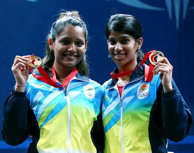 Dipika Pallikal (left) and Joshana Chinappa of India celebrate with their gold medals at the Glasgow CWG in 2014