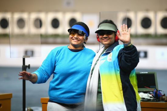 Gold medalist Rahi Sarnobat (left) and silver medalist Anisa Sayyed celebrate at the end of the women's 25m Air Pistol shooting