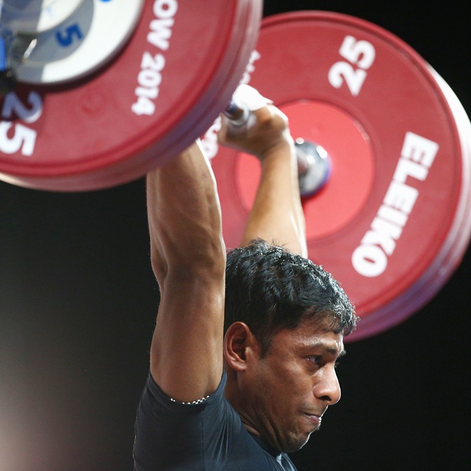 Sukhen Dey competes in the Clean and Jerk on his way to winning the gold medal in the men's 56kg weightlifting