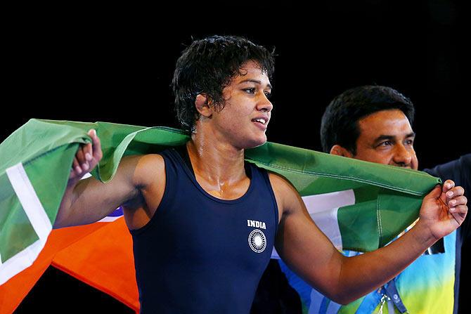 Babita Kumari of India celebrates winning the gold medal in the women's freestyle 55kg wrestling