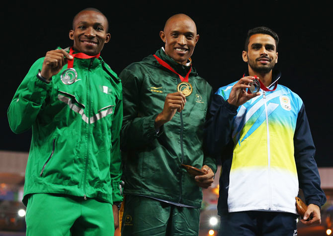 (Left-Right) Silver medalist Tosin Oke of Nigeria, gold medalist Khotso Mokoena of South Africa and bronze medalist Arpinder Arpinder Singh of India pose on the podium during the medal ceremony for the Men�s Triple Jump at Hampden Park on Saturday