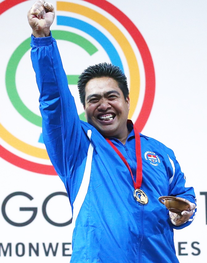 David Katoatau of Kiribati celebrates with his Gold medal after the Men's Weighlifting 75kg