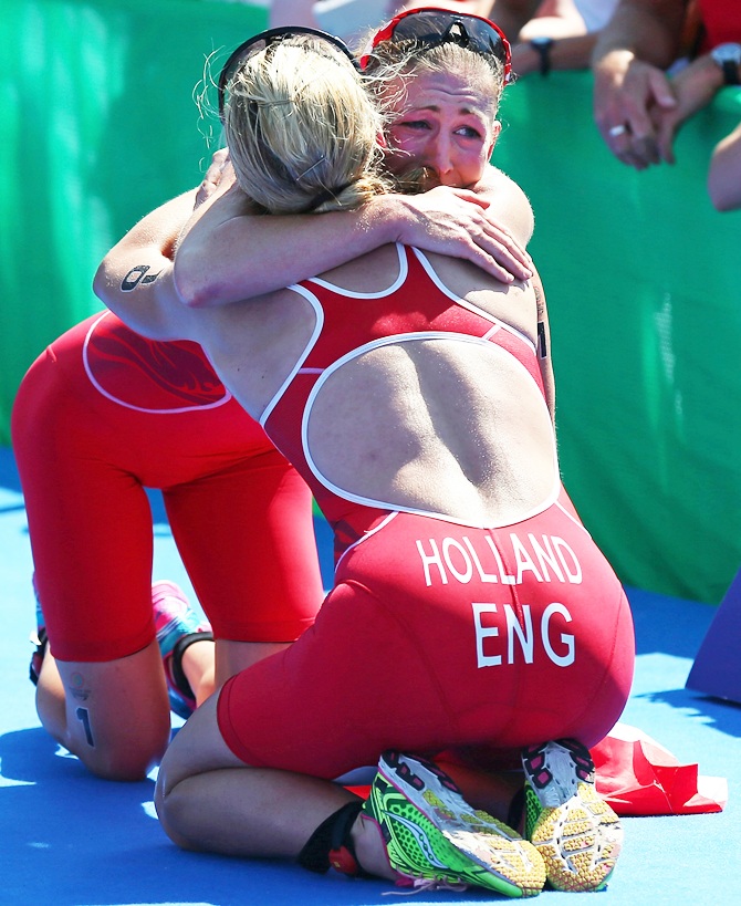 Jodie Stimpson of England celebrates with Vicky Holland of England after they win Gold and Bronze in the Women's Triathlon at Strathclyde Country Park during day one of the Glasgow 2014 Commonwealth Games