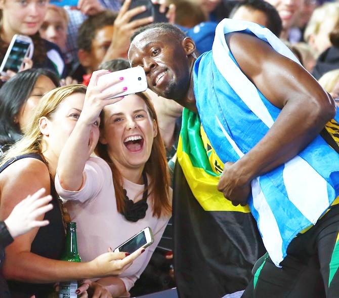 Usain Bolt of Jamaica greets fans as he celebrates winning gold in the Men�'s 4x100 metres relay final at Hampden Park during day ten of the Glasgow 2014 Commonwealth Games