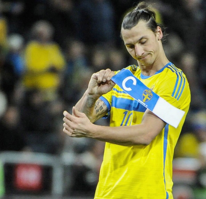 Sweden's forward Zlatan Ibrahimovic takes off the captain's armband