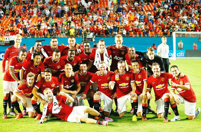 Manchester United pose for a photograph following their victory over Liverpool