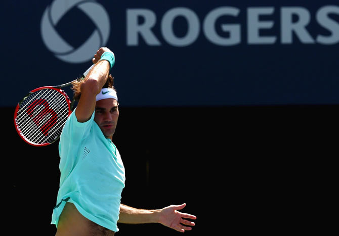 Roger Federer of Switzerland returns a shot to Jo-Wilfried Tsonga on Sunday