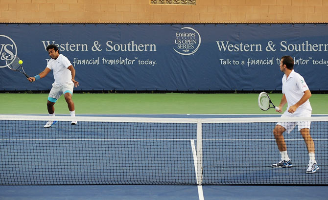 Leander Paes of India and Radek Stepanek of the Czech Republic return to Vasek Pospisil of Canada and Jack Sock during a doubles match on day 5 of the Western & Southern open at Linder Family Tennis Center in Cincinnati on Wednesday