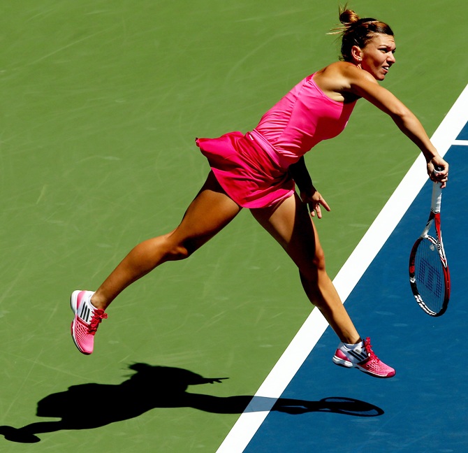 Simona Halep of Romania serves to Danielle Rose Collins of the United States