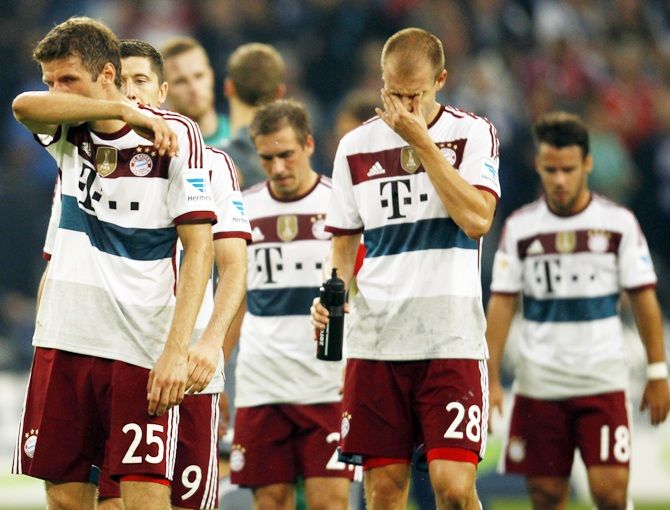 Bayern Munich's players react after their German first division Bundesliga match against Schalke 04 in Gelsenkirchen