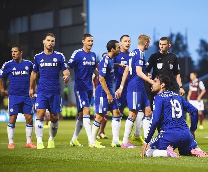 Chelsea players appeal to Referee Michael Oliver, as he books Diego Costa of Chelsea for diving