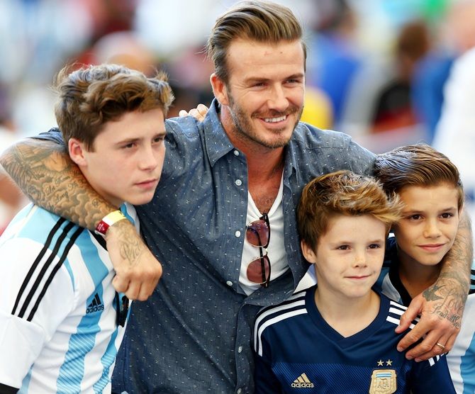 Former England international David Beckham and sons
