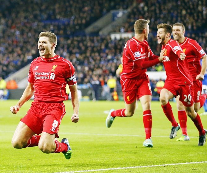 Liverpool's Steven Gerrard, left, celebrates after scoring 