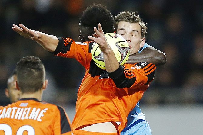 Image: Lorient's Benjamin Jeannot (right) is challenged by Olympique Marseille's Benjamin Mendy during their French Ligue 1 match at the Moustoir stadium in Lorient, on Tuesday