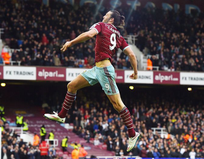 Andy Carroll of West Ham celebrates scoring their second goal during the Barclays Premier League match between West Ham United and Swansea City at Boleyn Ground in London on Sunday