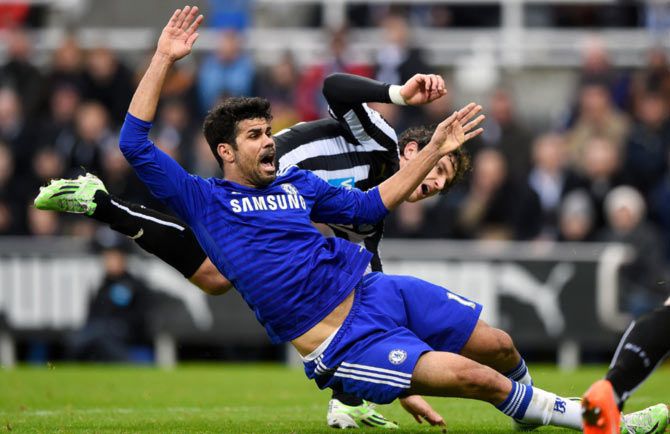 Diego Costa of Chelsea clashes with from Newcastle's Fabricio Coloccini