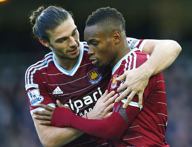 Diafra Sakho (right) of West Ham United celebrates with Andy Carroll after scoring his team's third goal against Swansea City