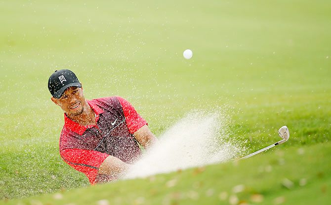 Tiger Woods plays a bunker shot on the fourth hole during the final round of the Hero World Challenge on Sunday