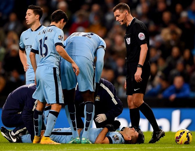 Sergio Aguero of Manchester City lies on the pitch injured