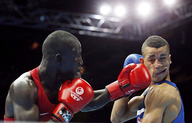 Kenya's Denis Okoth (left) lands a punch on England's Samuel Maxwell during their men's Light Welterweight boxing fight at the Commonwealth Games in Glasgow, Scotland on July 27