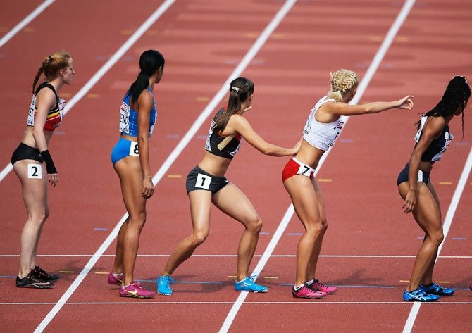 Athletes wait at the baton hand over in the Women's 4x400 metres relay final during day six of the 22nd European Athletics Championships at Stadium Letzigrund in Zurich on August 17