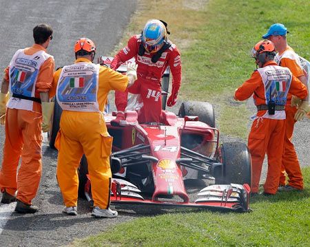 Ferrari Formula One driver Fernando Alonso of Spain steps out his car following an engine failure during the Italian F1 Grand Prix in Monza