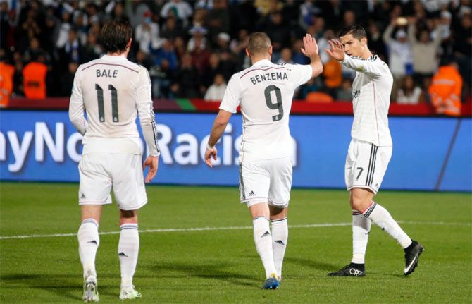 Karim Benzema (centre) celebrates scoring a goal with team mate Cristiano Ronaldo and Gareth Bale